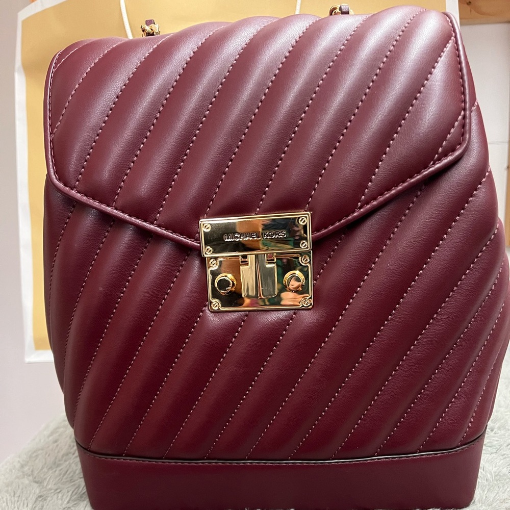 Michael Kors chain backpack merlot color. Brand new with tags